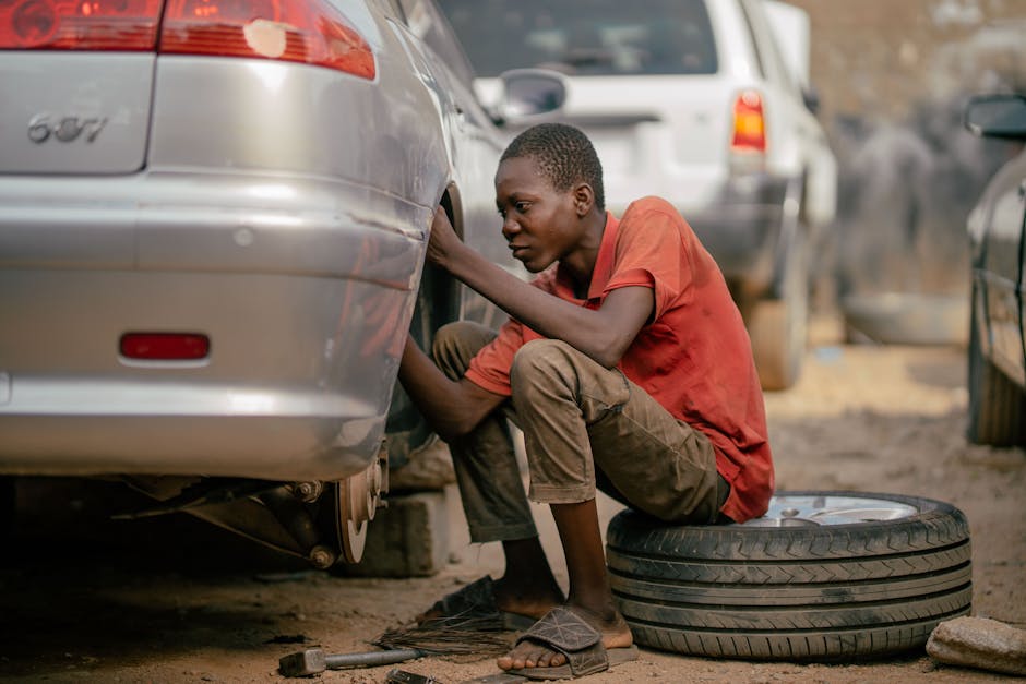 Mechanic professionally installing a car tire